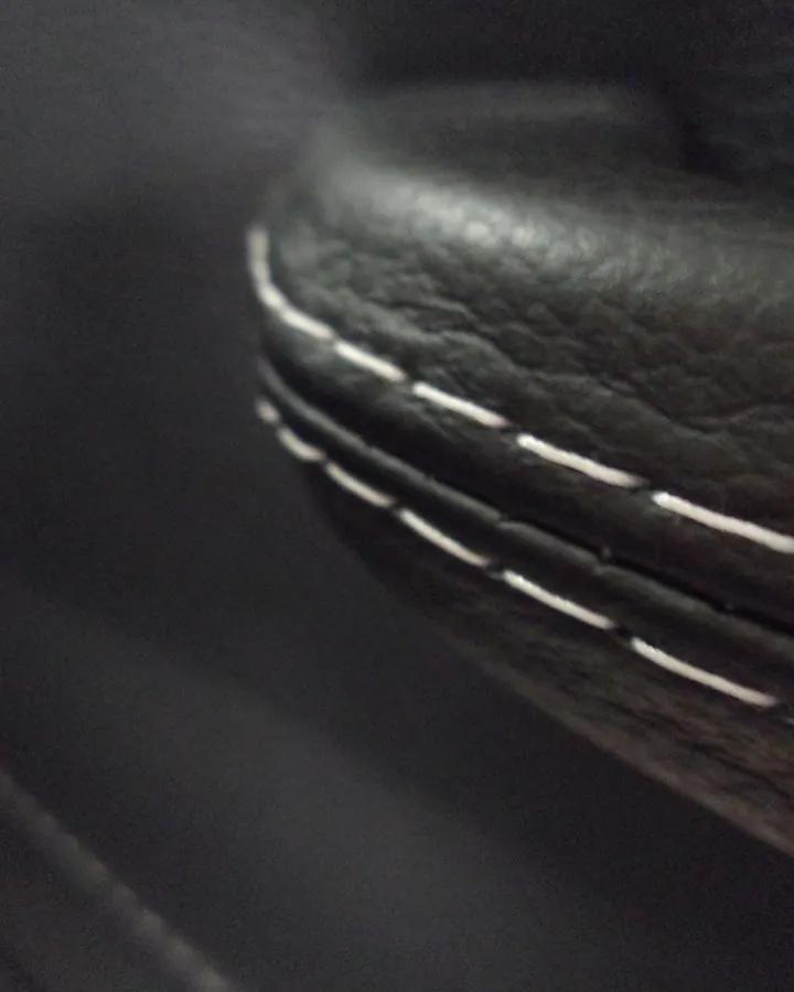 Close Up White Stitch On Black Leather Handle